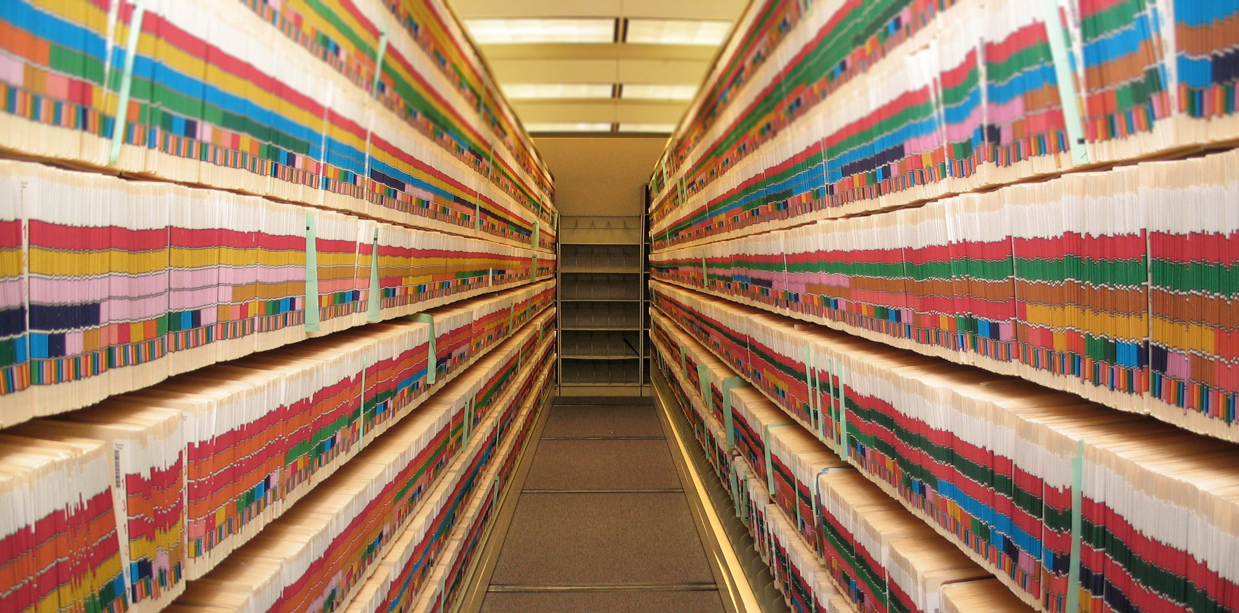 A long hallway with shelves of files.