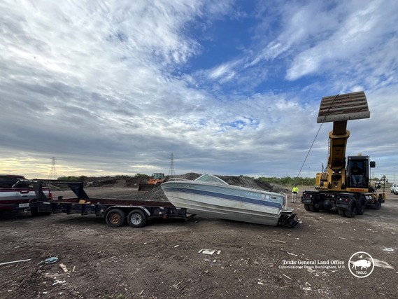A boat being loaded onto a trailer during the 2026 Brazoria County Vessel Turn-In Program