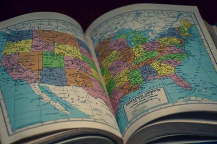 A history book open to a map of the United States of America.