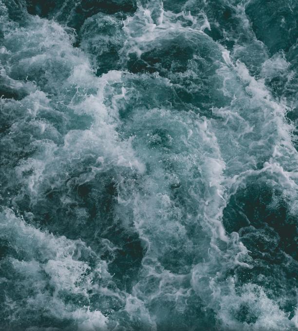 A stormy ocean with waves as seen from above.