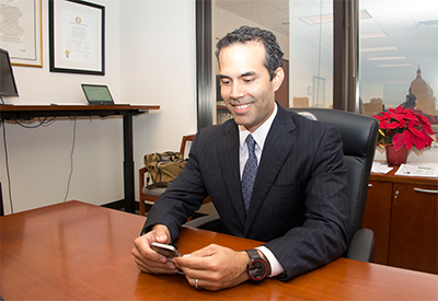 George P. Bush electronically signs paperwork.
